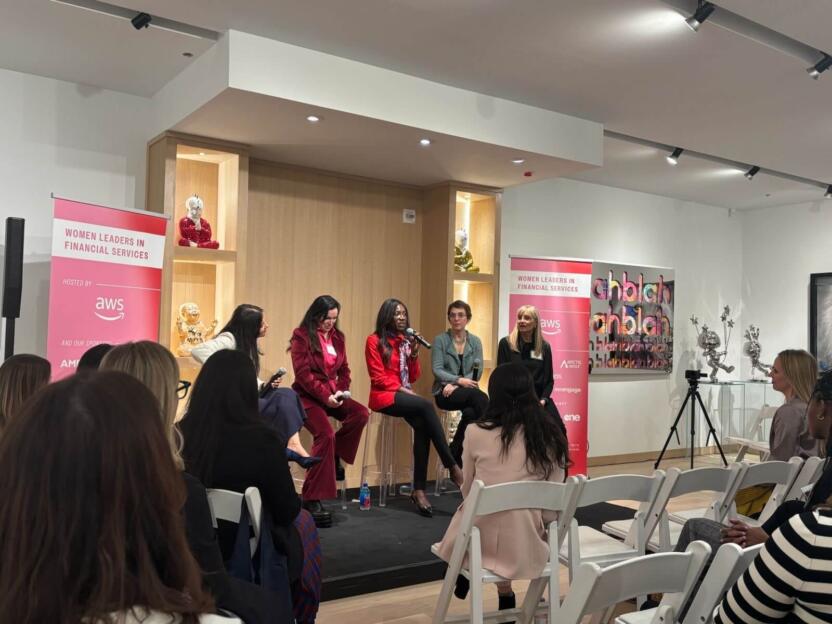 Women speaking on a panel at the AWS Women in the Cloud event