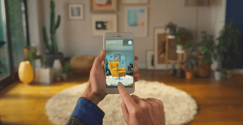 An example of a person using augmented reality to shop for furniture in their home